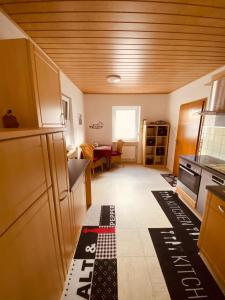 a small kitchen with a table in the background at Ferienhaus Gartenblick in Brieden in Brieden