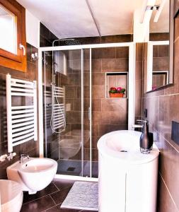 a bathroom with a sink and a shower at CASA ANGELA in Dervio