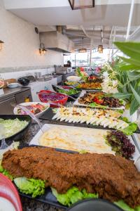 a buffet line of food in a restaurant at Asena Hotel in Kuşadası