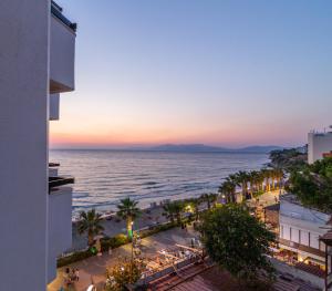a view of the ocean at sunset from a building at Asena Hotel in Kusadası