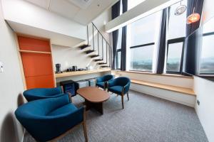 an office with blue chairs and a table and windows at Seoul Olympic Parktel in Seoul