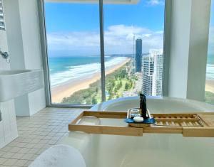 a bathroom with a tub with a view of the beach at Air on Broadbeach Beachfront 2Level stunning apartment with 180 degree views in Gold Coast