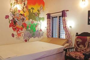 a bedroom with a bed and a painting on the wall at AbbA Marari Beach Villas & Homestay Mararikulam in Alleppey +113 photos