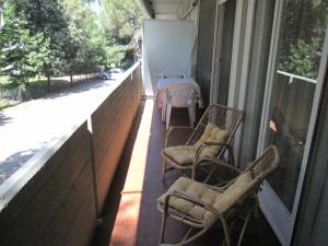 a balcony with chairs and a table on a porch at Appartamento Ritz in Grado