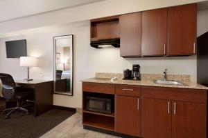 a kitchen with a sink and a desk in a room at Travelodge by Wyndham Hermiston in Hermiston