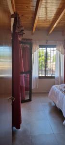 a bedroom with a bed and a window and a door at Susy Rental Depto N 3 in Malargüe +40 photos