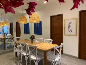 a dining room with a wooden table and chairs at youre at - The Majesty Apartment in Bandung