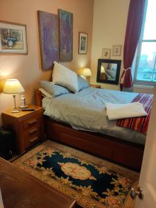 a bedroom with a bed and a mirror and a rug at Whitby Central walk to Beach Pier Flowergate in Whitby