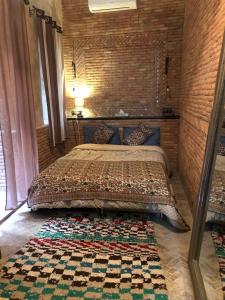 Ein Bett oder Betten in einem Zimmer der Unterkunft Riad Alamine