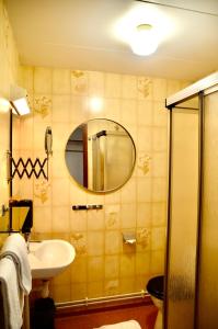 a bathroom with a sink and a mirror at Nature Shelter Hotel in Åsljunga