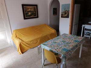 a room with a bed and a table in it at casa torre di ligny in Trapani