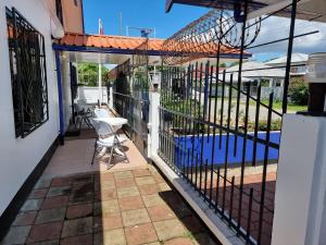 a patio with a fence and a swimming pool at Kwarts Appartementen in Paramaribo