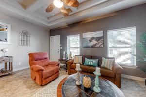 a living room with two chairs and a table at Sea Glass Condominiums #9 in South Padre Island