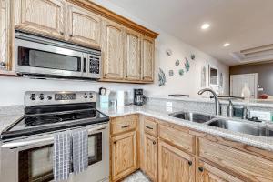a kitchen with a stove and a sink at Sea Glass Condominiums #9 in South Padre Island