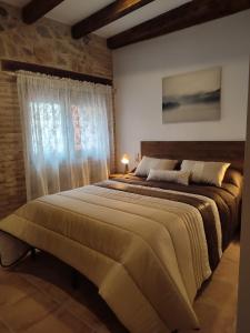 a bedroom with a large bed and a window at Casa Bruna in Cobisa