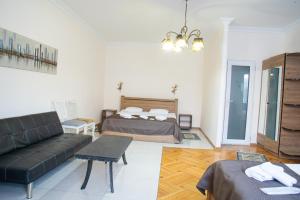 a living room with a couch and a bed at Stay Boutique Avlabari in Tbilisi City