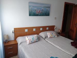 a bedroom with two beds and a painting on the wall at Casa EL CASTILLO,a 5 kilómetros de la playa in Mazarrón