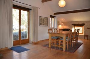 a kitchen and dining room with a table and chairs at Katy's Barn in Saint-Aulaye