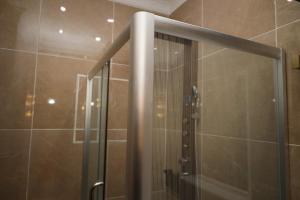 a shower with a glass door in a bathroom at NO.1 HOTEL in Abuja