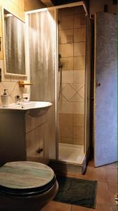 a bathroom with a shower and a toilet and a sink at La casa di Maya in Sassari +41 photos