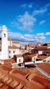 a view of a city with a white tower and roofs at La casa di Maya in Sassari