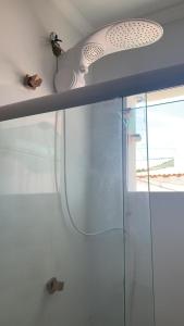 bagno con doccia e porta in vetro di Apartamento Duplex Mobiliado em São Pedro da Aldeia a São Pedro da Aldeia