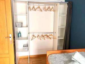 a bedroom with a closet with hangers and shoes at Apartamento Martín in Unquera