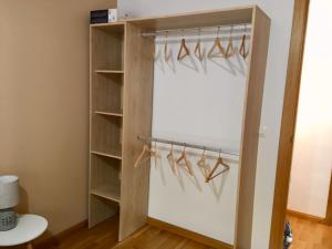 a closet with wooden shelves and hangers at Apartamento Martín in Unquera +3 photos