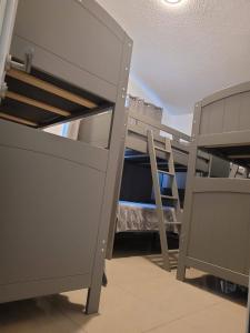 a room with two bunk beds and a ladder at Aquaville Dorado Moderna Villa 3 in Dorado