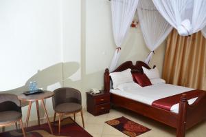 Postel nebo postele na pokoji v ubytování SS Hotel & Apartments Kampala