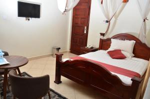 Postel nebo postele na pokoji v ubytování SS Hotel & Apartments Kampala