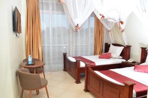Postel nebo postele na pokoji v ubytování SS Hotel & Apartments Kampala