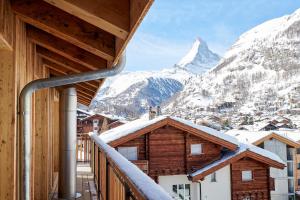 a balcony with a view of a mountain at Carina - Design&Lifestyle hotel in Zermatt