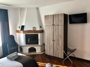 a bedroom with a cabinet and a fireplace at Volare Suites in Zagreb