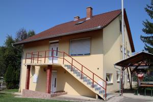 una casa con una escalera en el lateral de ella en Großes Ferienhaus Plattensee Balaton - nyaraló ház 6 szobával, 5 fürdőszobával, 3000 nm, en Szólád