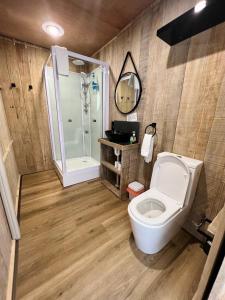 a bathroom with a toilet and a shower at Hillview Farmstay in Gundagai
