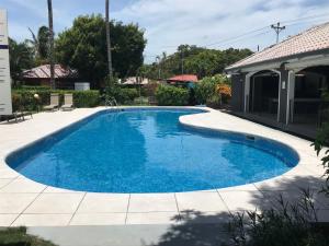 a swimming pool with blue water in a yard at Gray House Domenico in Potrero