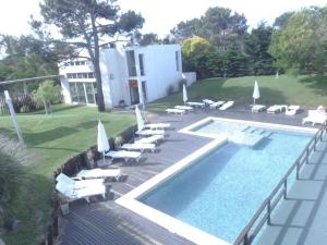 a swimming pool with lounge chairs and a swimming pool at Punta vacaciones -piscina solo en vacaciones y fines de semana largos- in Las Gaviotas +8 photos