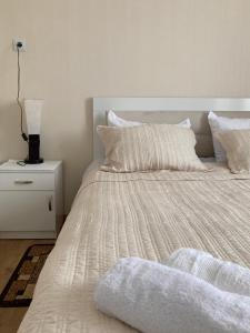 łóżko z białą pościelą i poduszkami w sypialni w obiekcie MOUNTAIN HEART w mieście Stepancminda