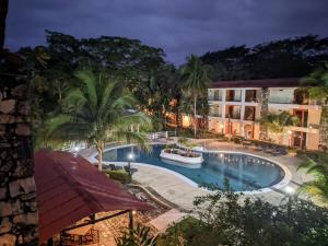 una vista aérea de la piscina del complejo por la noche en Hotel Plaza Palenque, en Palenque
