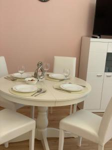 a white table with plates and wine glasses on it at Prater Zentrum in Vienna