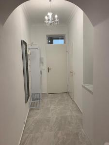 a hallway with two white doors and a chandelier at Prater Zentrum in Vienna