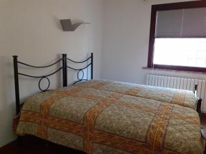 a bed in a bedroom with a window at Gervasella in Pontedera