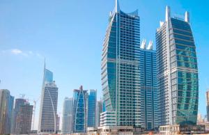 a city with tall buildings and a sky background at Armada Avenue Hotel - formerly Armada BlueBay Hotel in Dubai