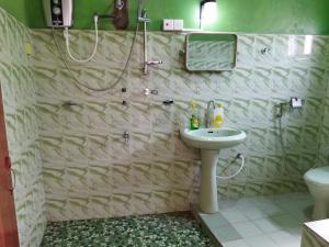 a bathroom with a sink and a shower at 7 guest 3room apartment in Matara