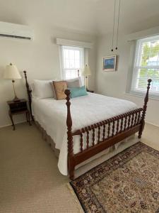 a bedroom with a large bed in a room at Bermuda At the Beach One-Bedroom in Paget Parish