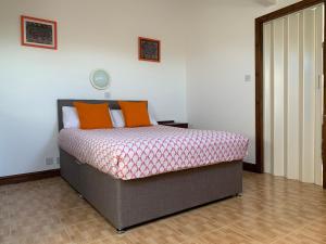 a bedroom with a bed with orange pillows on it at Manchester Stay Hotel in Manchester