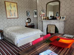 a bedroom with a bed and a table and a mirror at Aberley House in Liverpool