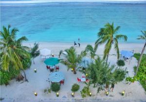 an aerial view of a beach with tables and umbrellas at Rivethi Beach in Hulhumale