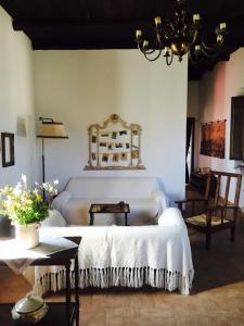 a bedroom with a white bed and a chandelier at Tenute Pacelli - Azienda Agricola in Malvito